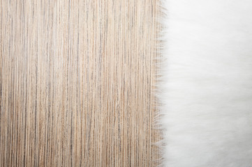 fur carpet background on light wooden floor. top view, copy space