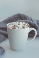 Cocoa with marshmallows on a cozy gray background