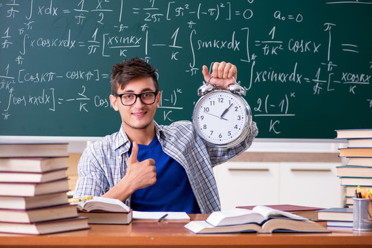 Young male student studying math at school