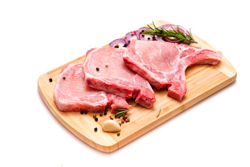 pork chop, steak, pieces of pork on a wooden board. isolate on white background