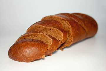 black bread is sliced in pieces. on