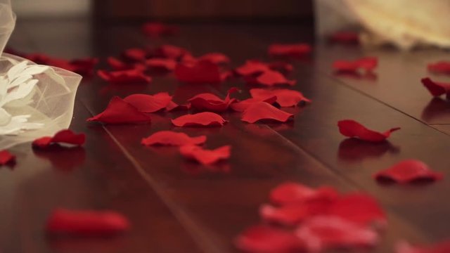 wedding dress and rose petals on the floor