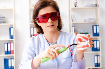 Female doctor working on new teeth implant 