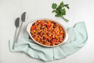 Baking dish with chili con carne on light background, top view