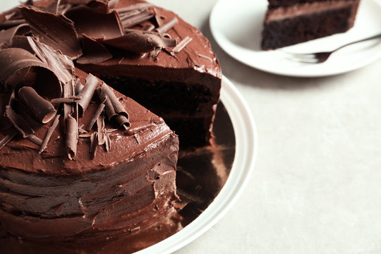 Tasty homemade chocolate cake on table, closeup. Space for text