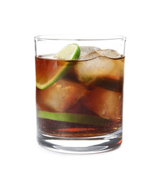 Glass of cocktail with cola, ice and cut lime on white background