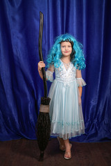 beautiful girl with blue hair standing with black broom
