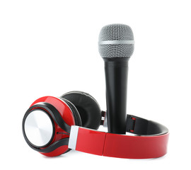Microphone with stylish headphones on white background