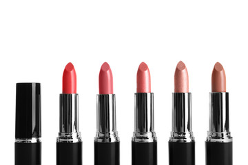 Different lipsticks on white background. Cosmetic product