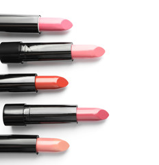 Obraz premium Different lipsticks on white background, top view