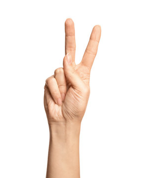 Woman showing number two on white background, closeup. Sign language