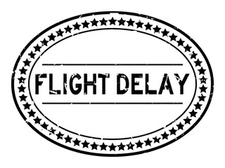 Grunge black flight delay word oval rubber seal stamp on white background