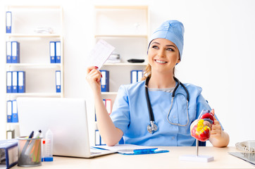 Young female doctor cardiologist sitting at the hospital 