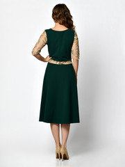 Fototapeta premium Young beautiful woman posing in new dark black fashion winter dress backside rear view