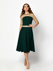 Young beautiful woman posing in new black fashion winter dress full body on a white 