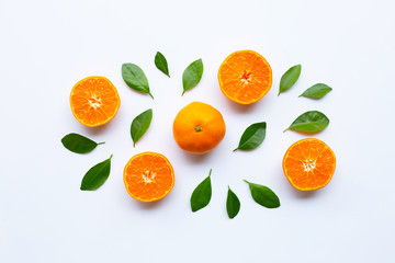 Fresh orange citrus fruit with green leaves on white.