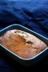 Homemade baked banana bread on a dark blue tablecloth. Selective focus.