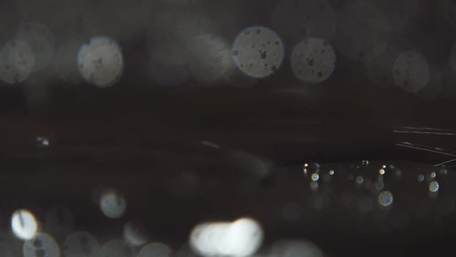 Fairylike black and white water crawling like volcano lava in slow motion  