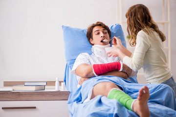 Fototapeta premium Loving wife looking after injured husband in hospital 