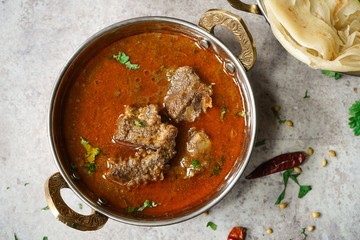 Lamb Mutton goat curry served with Paratha, overhead view