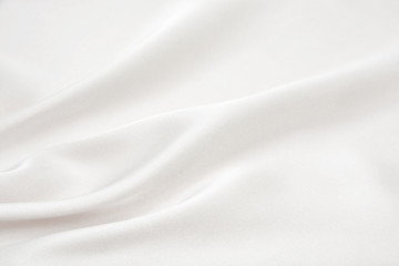 The texture of the satin fabric of white color for the background