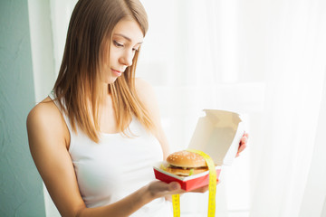 Diet. The concept of healthy and unhealthy nutrition. The model plus size makes a choice in favor...