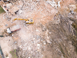 top view of demolition site. destruction of old building. heavy machinery clearing out construction...