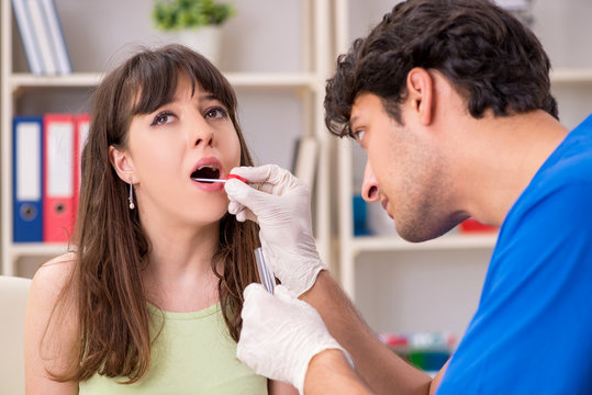 Doctor getting saliva test sample in clinic hospital