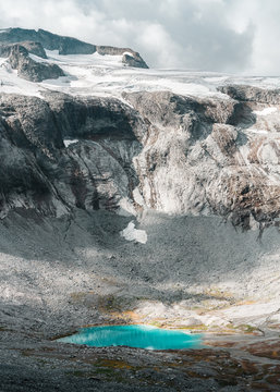 A turquoise lake beneath glaciated peaks. 
