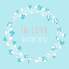 Vector hand drawn illustration of text IN LOVE WITH YOU and floral round frame on blue background. Colorful.