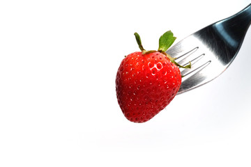healthy Strawberry impale with stanley fork on white isolated background