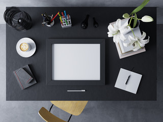 mock up design template to showcase artwork of empty poster in modern workspace in horizontal frame resting on a black polished table in straight top view