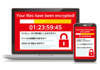 ランサムウェアウイルスに感染した画面を表示するパソコンとスマホ