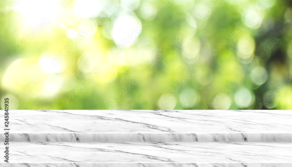 Aufkleber Empty white marble table top with blur tree in park with bokeh light at background,Mock up template for display of your design,Banner for advertise of product,panorama view