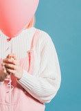 Girl with a pink helium balloon