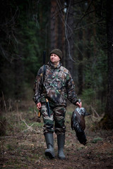 Fototapeta premium grouse hunter returns from the forest with prey