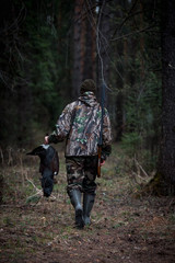 Naklejka premium grouse hunter returns from the forest with prey