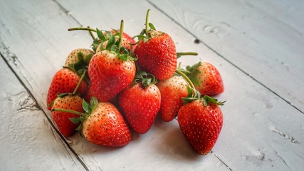 Fresh strawberries on wooden table.
