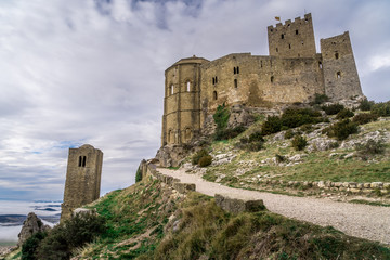 Obraz premium Winter view of medieval partially restored Romanesque Loarre castle near Huesca in Aragon region Spain with round towers, donjon, on top of a high rock