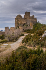 Fototapeta na wymiar Winter view of medieval partially restored Romanesque Loarre castle near Huesca in Aragon region Spain with round towers, donjon, on top of a high rock