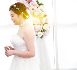 bride in white dress with bouquet of flowers