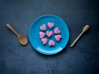 Kleeb Lamduan,Thai shortbread cookies heart shape in blue plate on black background for love issue.