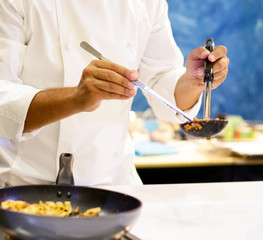 Chef cooking pasta, Chef serves spaghetti carbonara on the plate in the kitchen