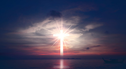 Obraz na płótnie Canvas Concept of Jesus Christ: white cross on sunset sky background