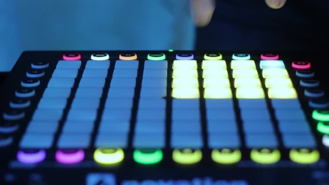 DJ plays on the car audio controller and plays music in the club