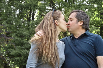Fototapeta premium loving couple kissing standing in the Park