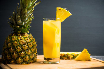 Fresh pineapple beverage on rustic background. Selective focus. Shallow depth of field.