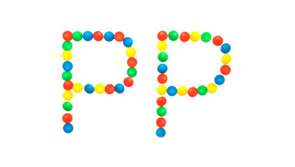 Multi-colored vitamins pills that are lined with the letter Vitamin PP, close-up