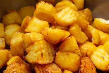 Fried potatoes with a golden crust in a deep fryer, close-up. junk food, spud