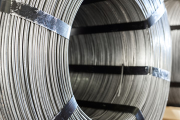 Factory stock wire. Wire spools lie on multi-tiered racks.